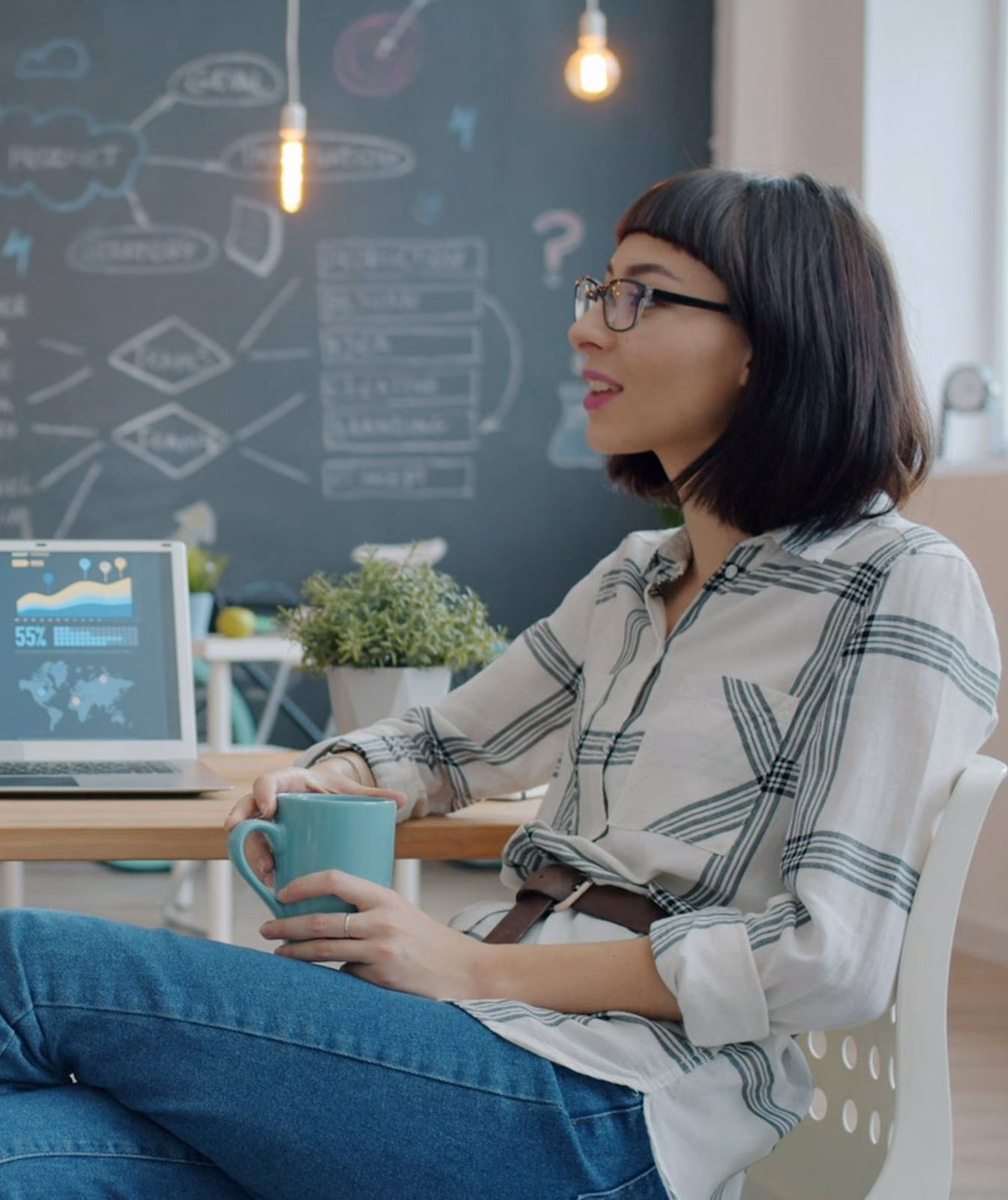 Two colleagues talking through an idea at a desk.