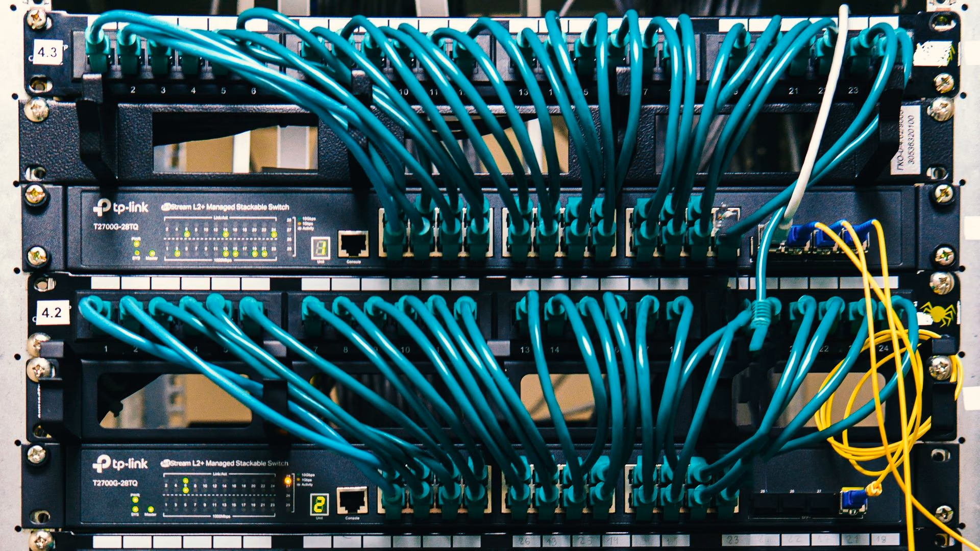 Neatly dressed patch cabling running across a network rack.